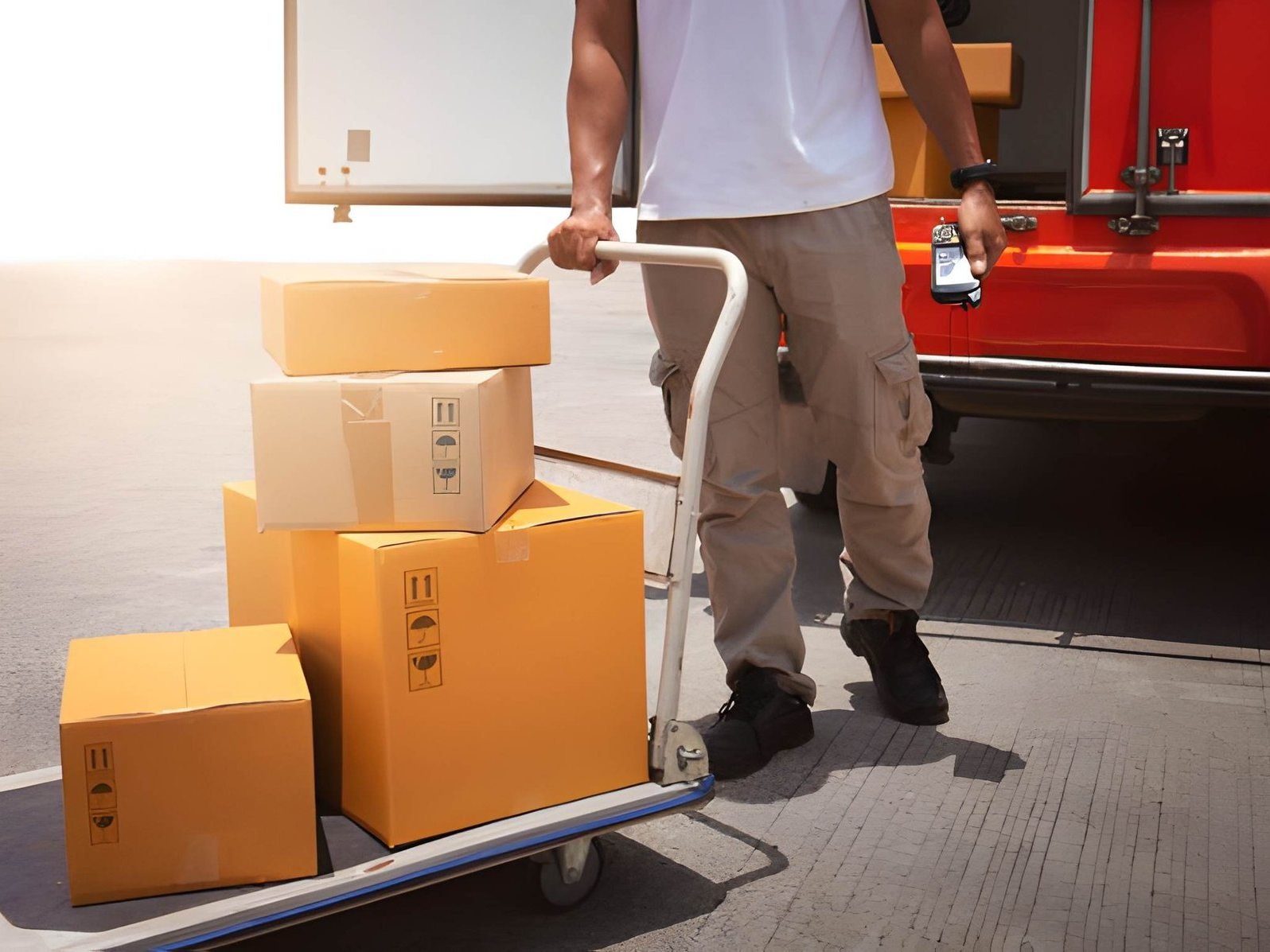 A man is loading boxes onto a dolly