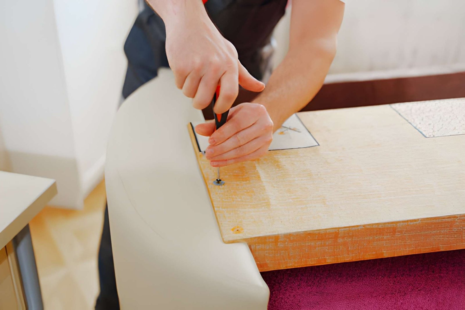 Flat-pack furniture being assembled with tools