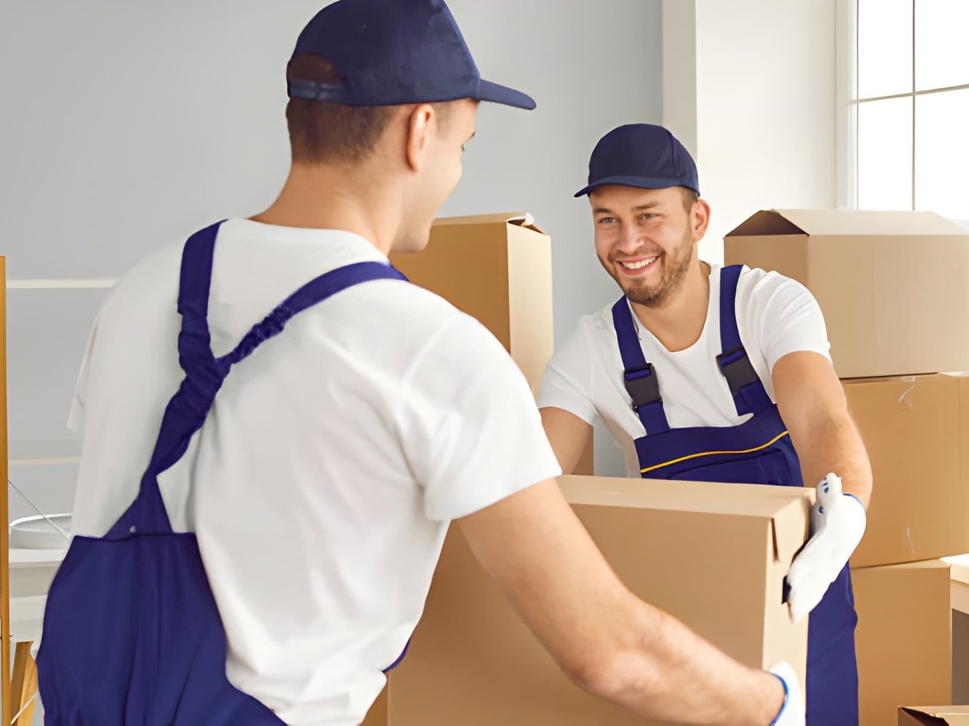 Two men in blue overalls and white t shirts
